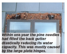 Within one year the pine needles had filled the back gutter drastically reducing its water capacity. This was mostly caused by the large plate hinges.