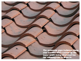 The excessive gaps between these clay pantiles were caused by the cover width being stretched too far, allowing rain to drive in