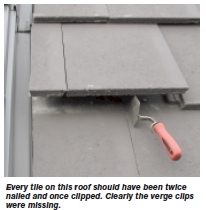 Every tile on this roof should have been twice nailed and once clipped. Clearly the verge clips were missing.