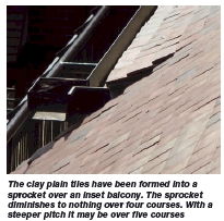   The clay plain tiles have been formed into a sprocket over an inset balcony. The sprocket diminishes to nothing over four courses. With a steeper pitch it may be over five courses